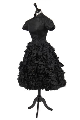 Lot 235 - An early Hubert de Givenchy black paper taffeta cocktail dress, circa 1952