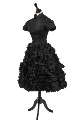 Lot 277 - An early Hubert de Givenchy black paper taffeta cocktail dress, circa 1952