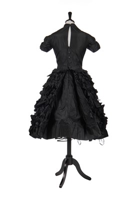 Lot 235 - An early Hubert de Givenchy black paper taffeta cocktail dress, circa 1952