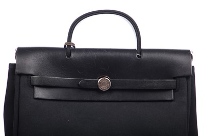 Lot 54 - An Hermès Herbag in black canvas and leather, modern