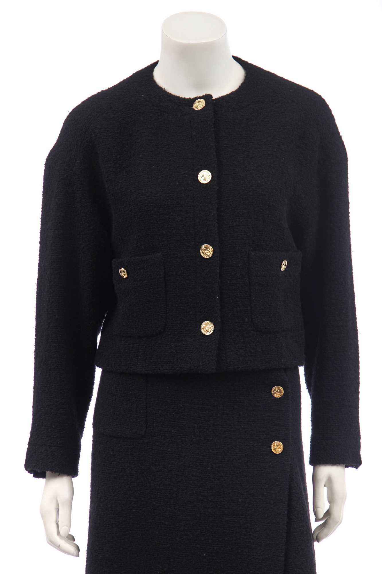 Lot 18 - A Chanel black bouclé wool suit, 1980s