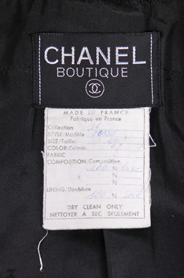 Lot 18 - A Chanel black bouclé wool suit, 1980s