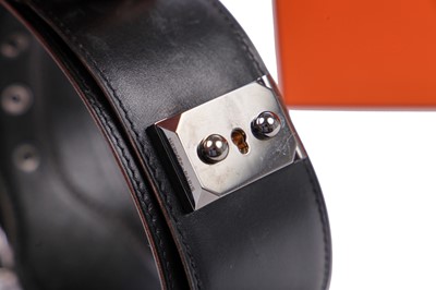 Lot 61 - An Hermès black leather belt with metal 'lock' clasp, modern