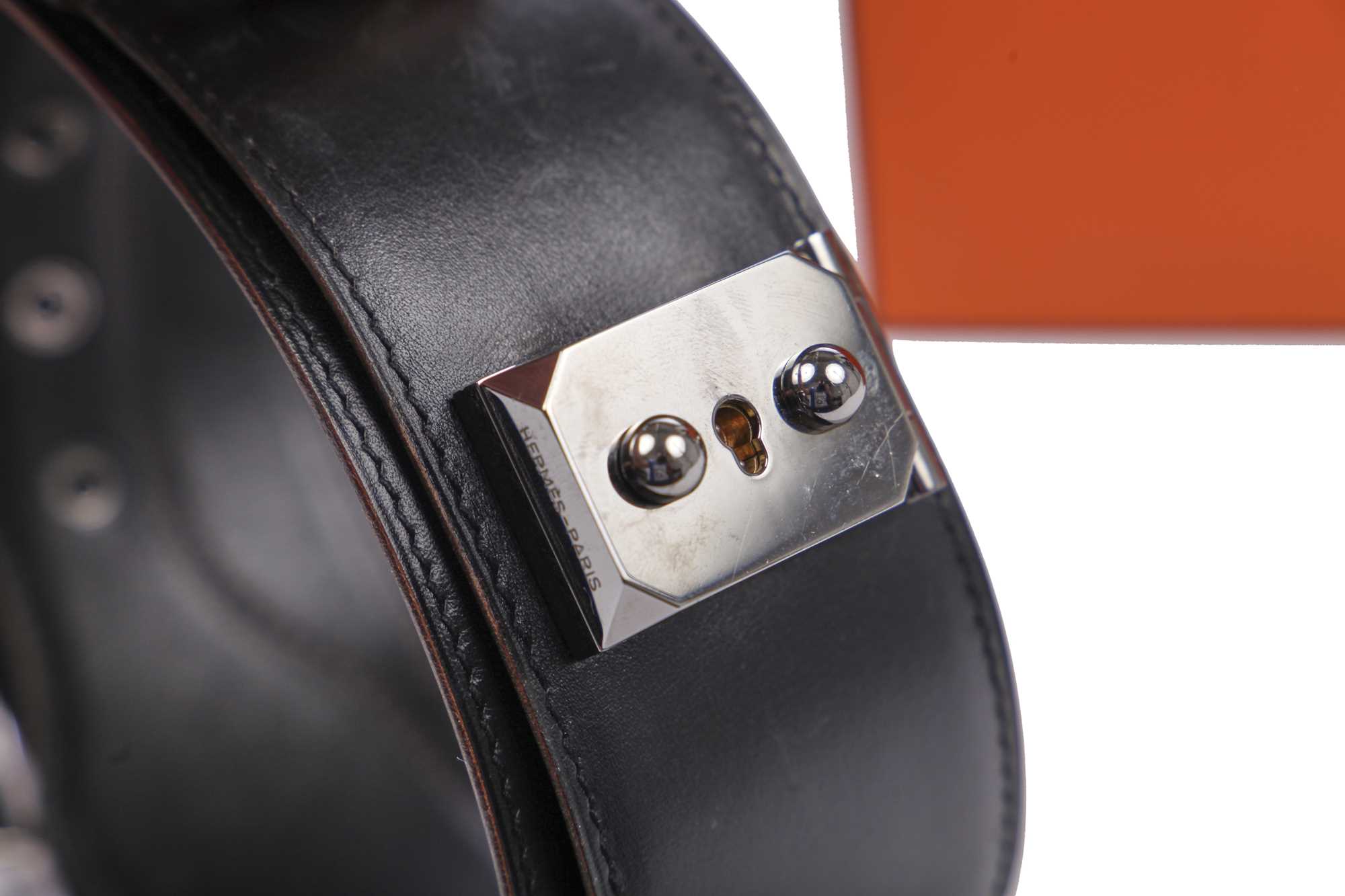 Lot 56 - An Hermès black leather belt with metal 'lock' clasp, modern
