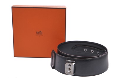 Lot 56 - An Hermès black leather belt with metal 'lock' clasp, modern