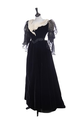 Lot 413 - An Alfred Manning of Dublin black velvet evening gown with three bodices, circa 1900