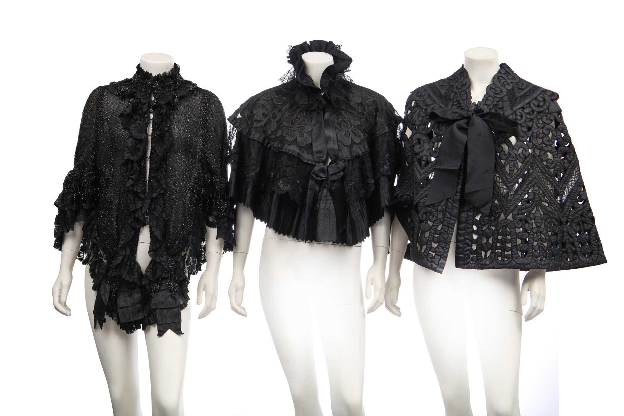 Lot 416 - Two black cut-work silk capelets and others, circa 1895