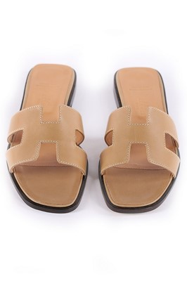 Lot 326 - A pair of Hermès beige leather 'Oran' sandals,...