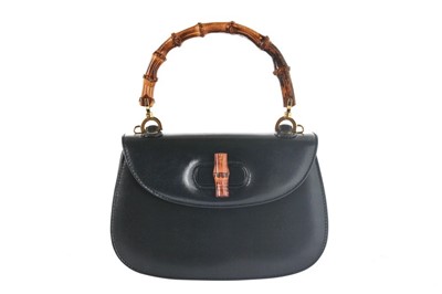 Lot 101 - A Gucci navy leather handbag with bamboo...