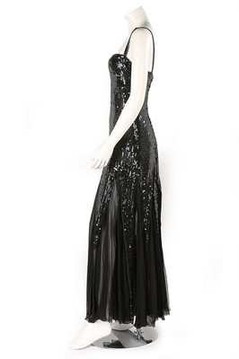 Lot 141 - A Loris Azzaro black sequinned evening gown,...
