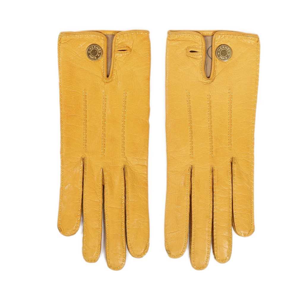 Lot 220 - A pair of Hermès yellow leather gloves and...