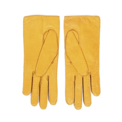 Lot 220 - A pair of Hermès yellow leather gloves and...