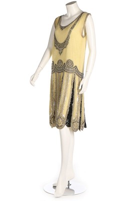 Lot 253 - A primrose yellow beaded dress, circa 1925, un-...