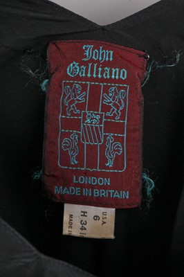 Lot 372 - A John Galliano black bias-cut viscose dress, 'Panniers' collection, Spring-Summer 1987