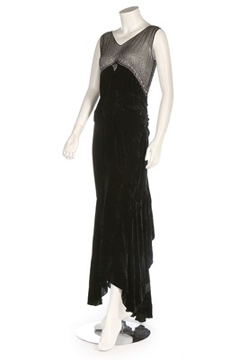 Lot 272 - A black velvet evening dress, early 1930s, the...