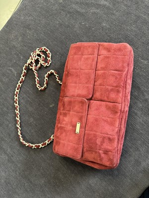 Lot 162 - A Chanel square-quilted burgundy suede flap bag, 2000-2002