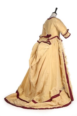 Lot 300 - A yellow and wine silk gown, 1870s, bust...