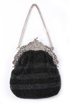 Lot 93 - A beaded purse with ornate continental silver...