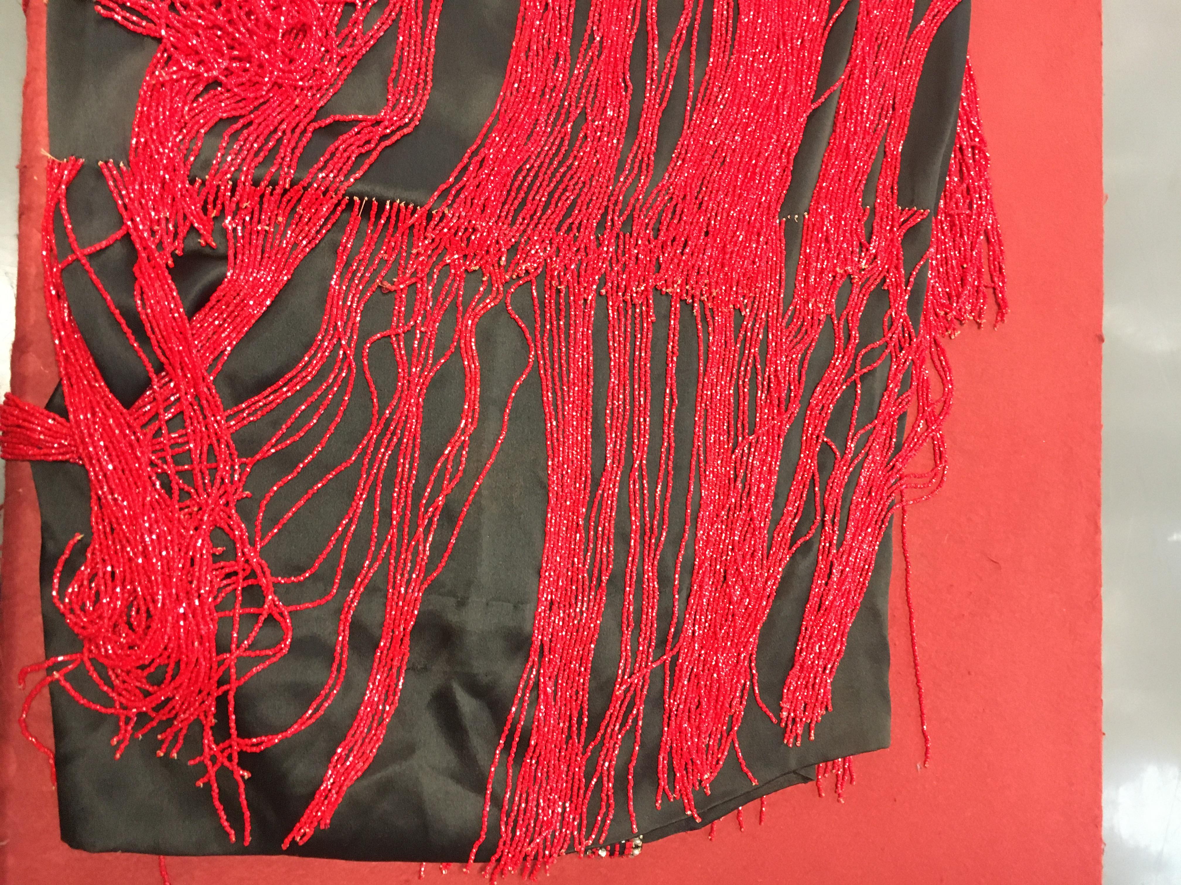 Sarin Flapper Lot 401 - A beaded black satin flapper dress, circa