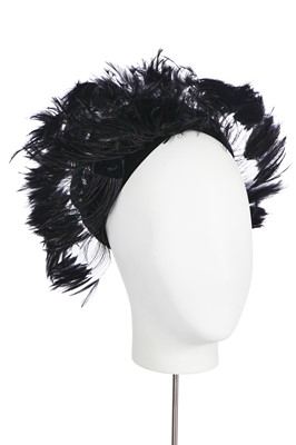 Lot 157 - A Christian Dior hat adorned with black feathers, 1960s