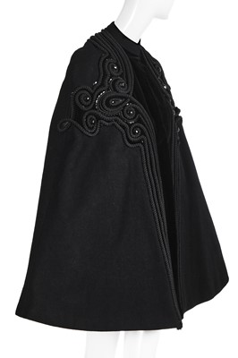 Lot 121 - A Pierre Balmain couture black wool cape, circa 1950