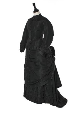 Lot 282 - A black faille mourning gown, late 1870s,...
