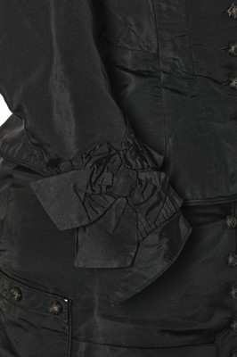 Lot 282 - A black faille mourning gown, late 1870s,...