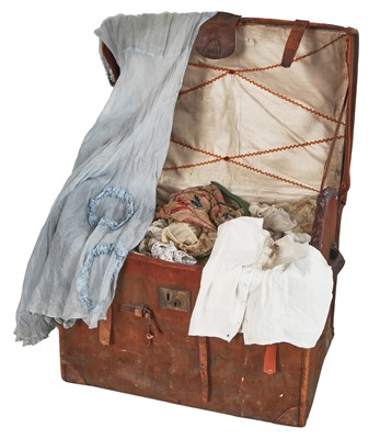 Lot 411 - A leather bound canvas trunk containing lace trimmings, men's shirts and lingerie