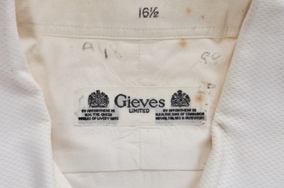 Lot 411 - A leather bound canvas trunk containing lace trimmings, men's shirts and lingerie