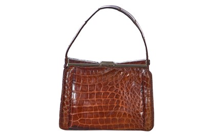 Lot 73 - 'Evita' interest: a brown crocodile handbag, circa 1945 used in the 1996 film
