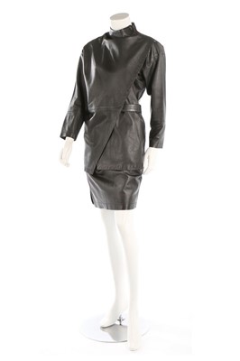 Lot 421 - An Issey Miyake black leather suit, mid 1980s,...