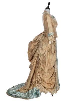 Lot 419 - A pale blue and ivory and silk evening gown with two bodices, 1883-85