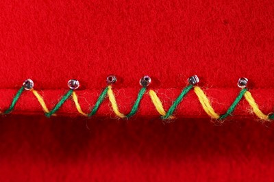 Lot 328 - A Mexican-style red felt appliqué jacket, 1950