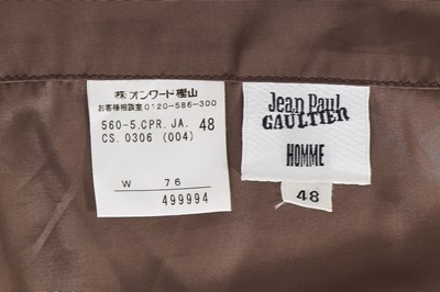 Lot 163 - A Jean Paul Gaultier men's brown polyester apron, modern