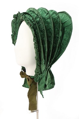 Lot 488 - A green silk caleche bonnet, early 19th...