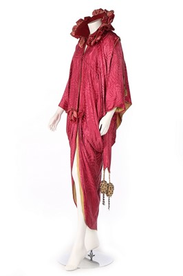 Lot 494 - A rose pink damask silk opera coat, circa 1910,...