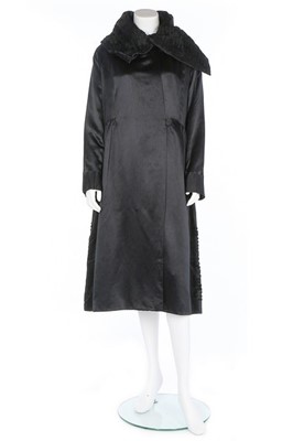 Lot 495 - A Paquin black satin coat, 1919, large woven...