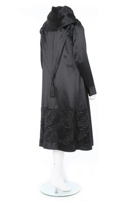 Lot 182 - A Paquin black satin coat, 1919, large woven...