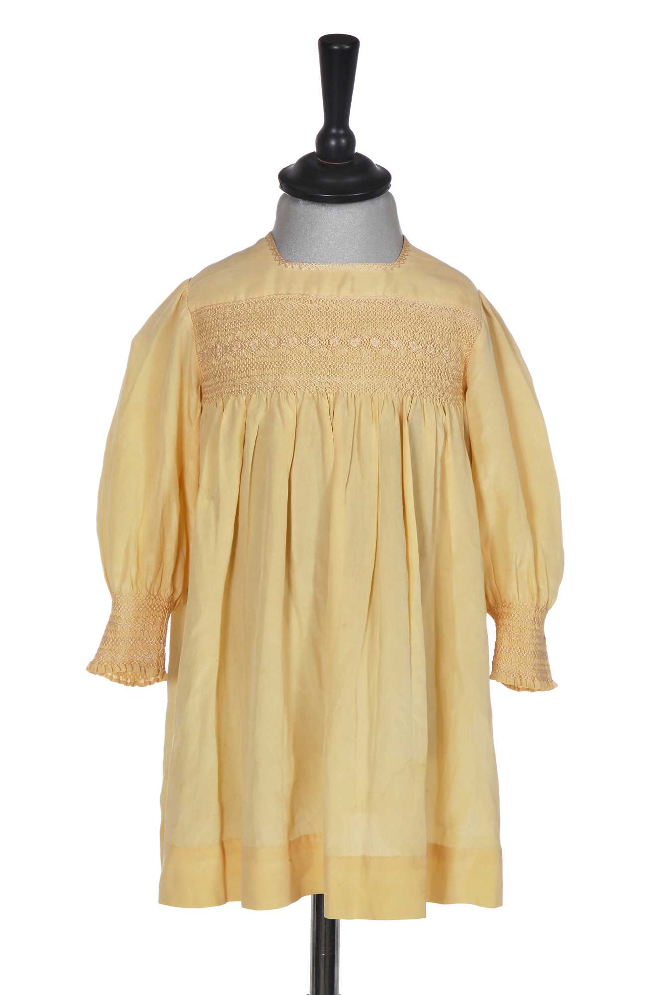 Lot 495 - A Smith & Co. primrose silk smocked dress, worn by Princess Elizabeth, circa 1930