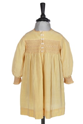 Lot 495 - A Smith & Co. primrose silk smocked dress, worn by Princess Elizabeth, circa 1930