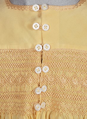 Lot 495 - A Smith & Co. primrose silk smocked dress, worn by Princess Elizabeth, circa 1930