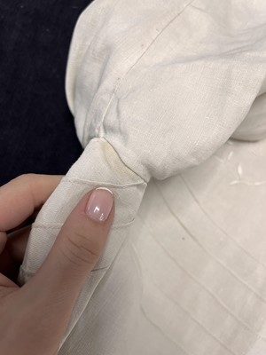 Lot 503 - A rare Redfern ivory linen summer sporting suit, circa 1905