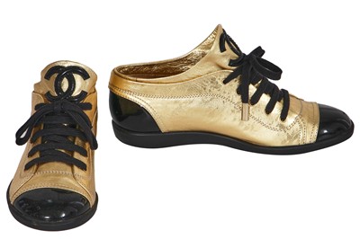 Lot 41 - A pair of Chanel black and gold sneakers, 2000s