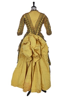 Lot 416 - An unusual yellow 'peacock' evening gown, circa 1875