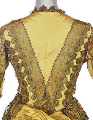 Lot 416 - An unusual yellow 'peacock' evening gown, circa 1875