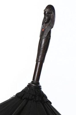 Lot 422 - A black silk parasol with carved ebony...