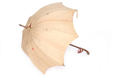 Lot 422 - A black silk parasol with carved ebony...