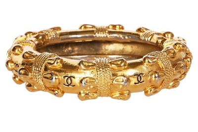 Lot 21 - A Chanel gold tone bangle, late 1970s