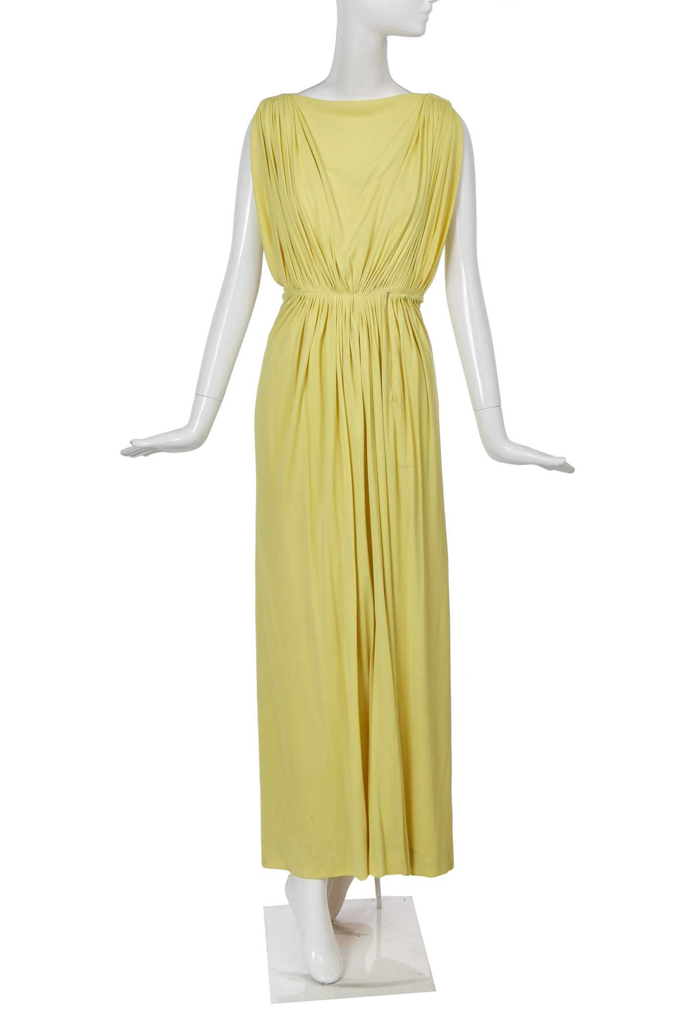 Lot 353 - A Madame Grès haute couture primrose jersey evening gown, circa 1963