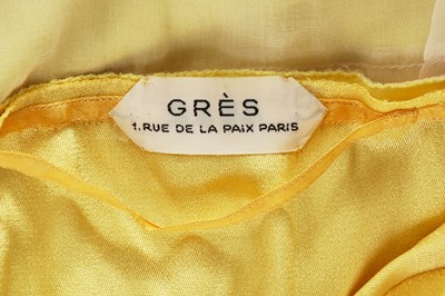 Lot 353 - A Madame Grès haute couture primrose jersey evening gown, circa 1963
